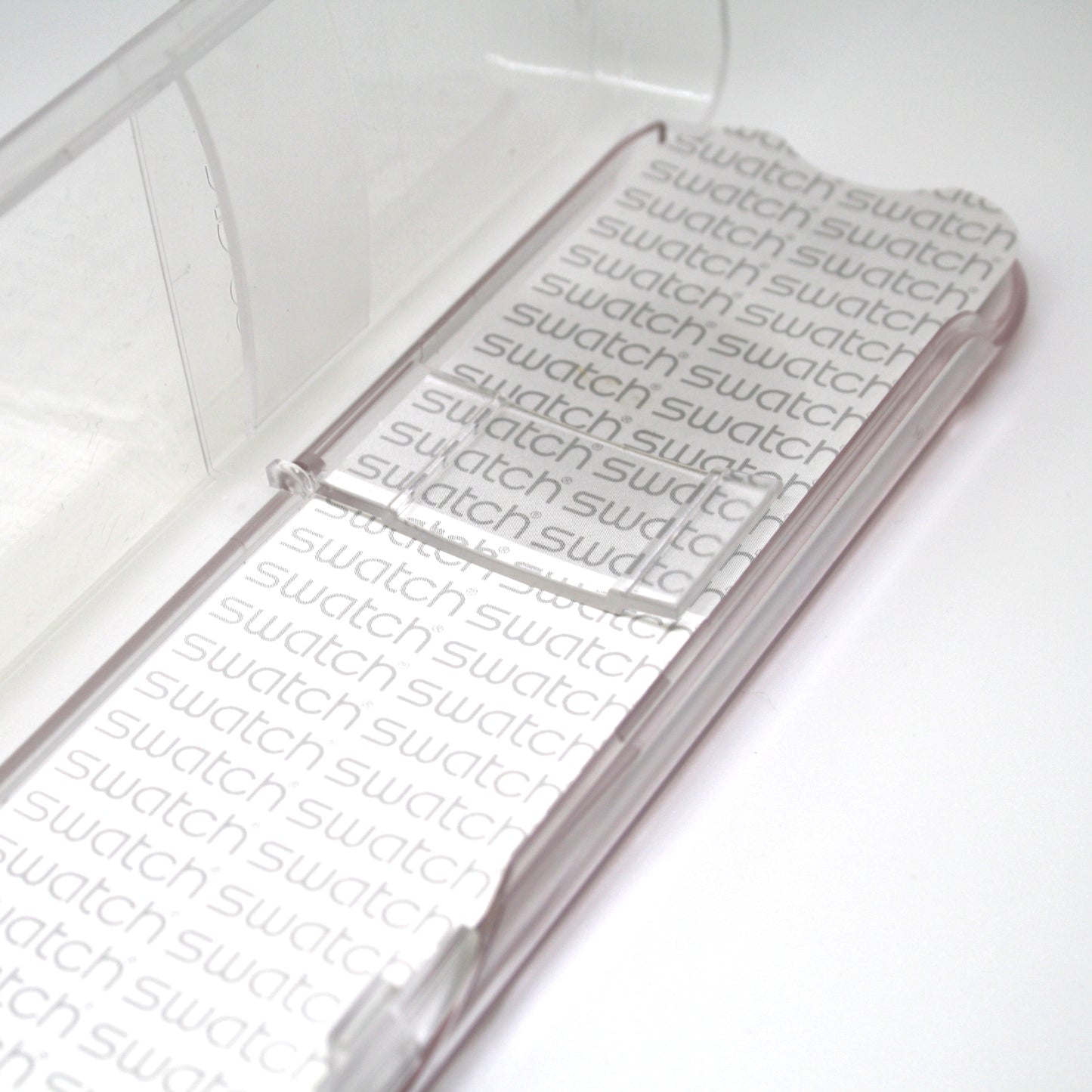 Clear plastic packaging with 'swatch' branding on a white background