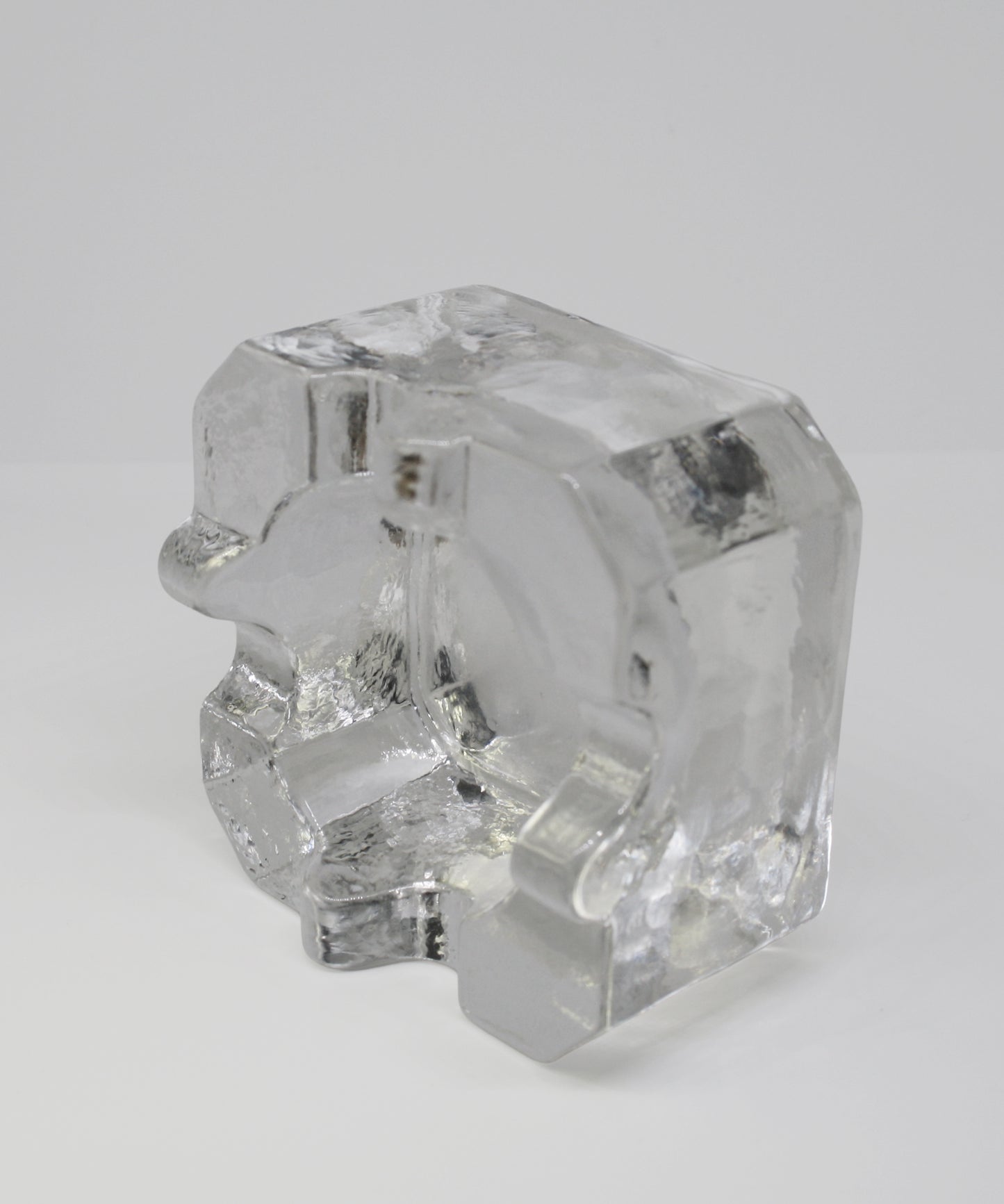 Clear glass ashtray on a white background