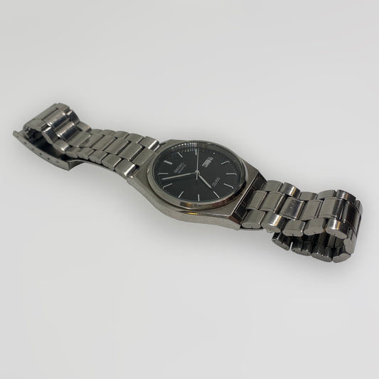 Silver watch with a black face on a white background