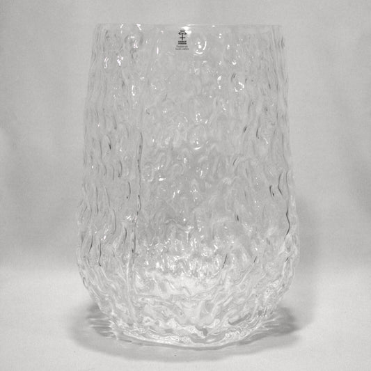 Clear textured glass vase on a white background