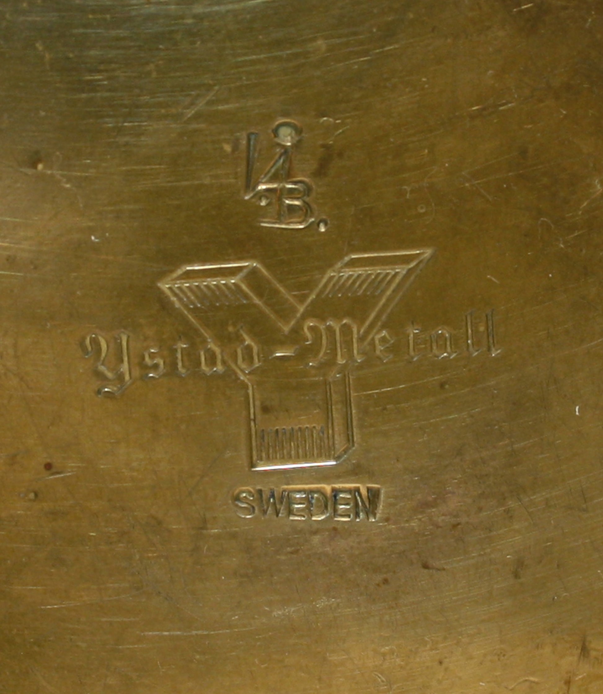 Bottom of a brass candle holder with 'Ystad Metall' branding