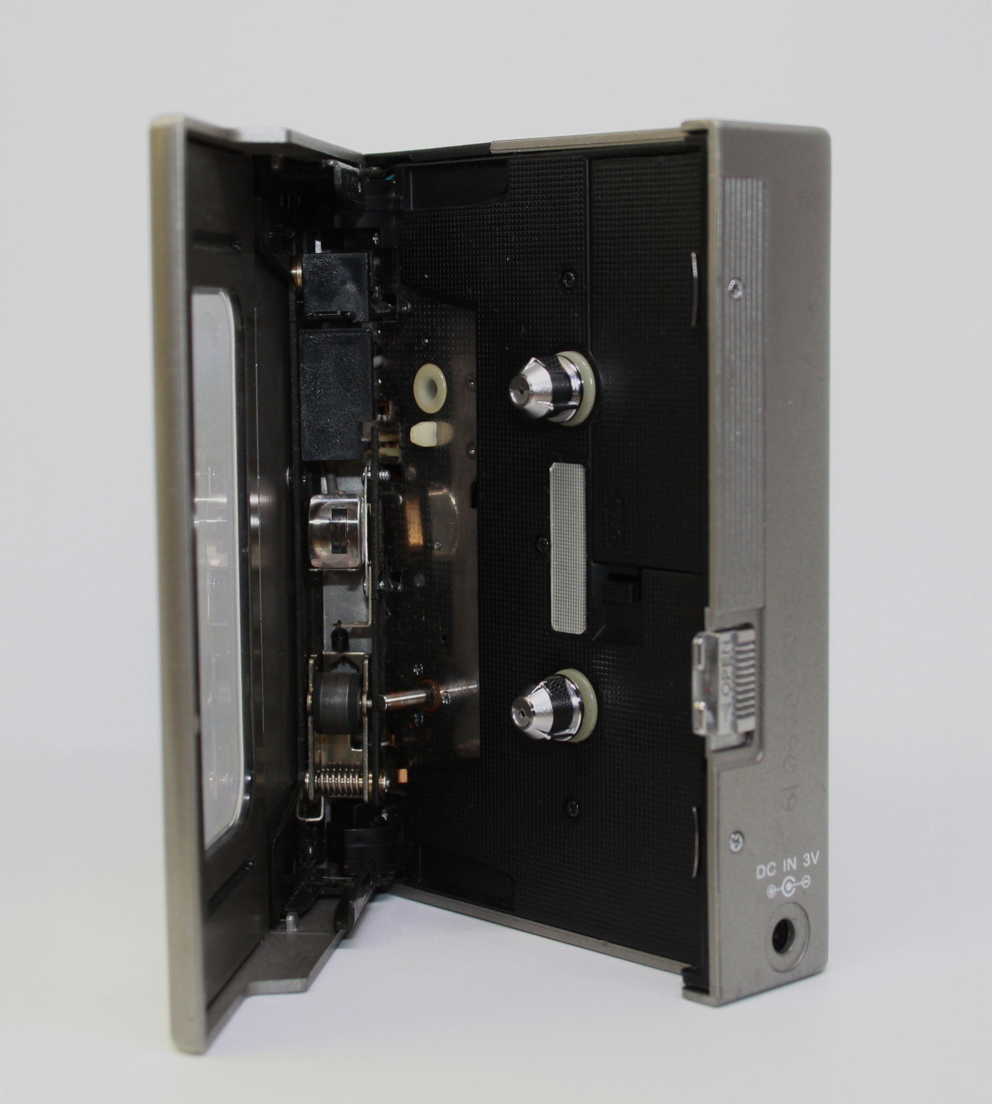 Open cassette tape player on a white background