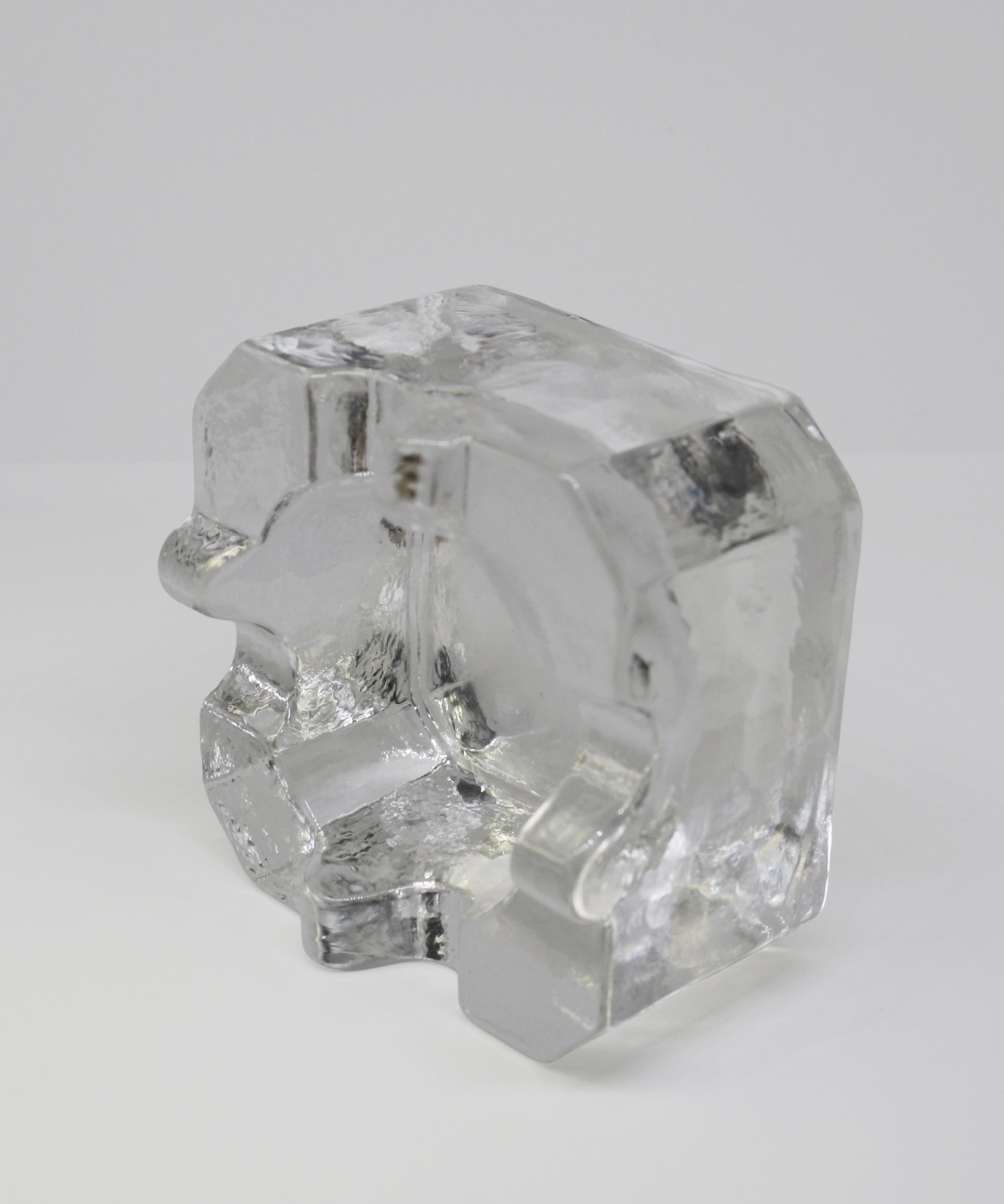 Clear glass ashtray on a white background