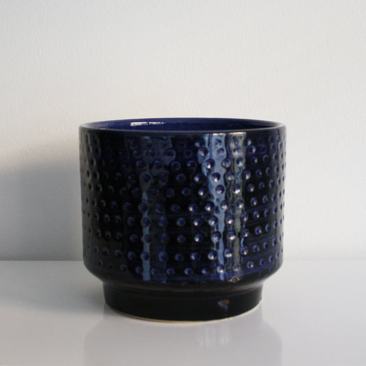 Blue textured ceramic pot on a white background